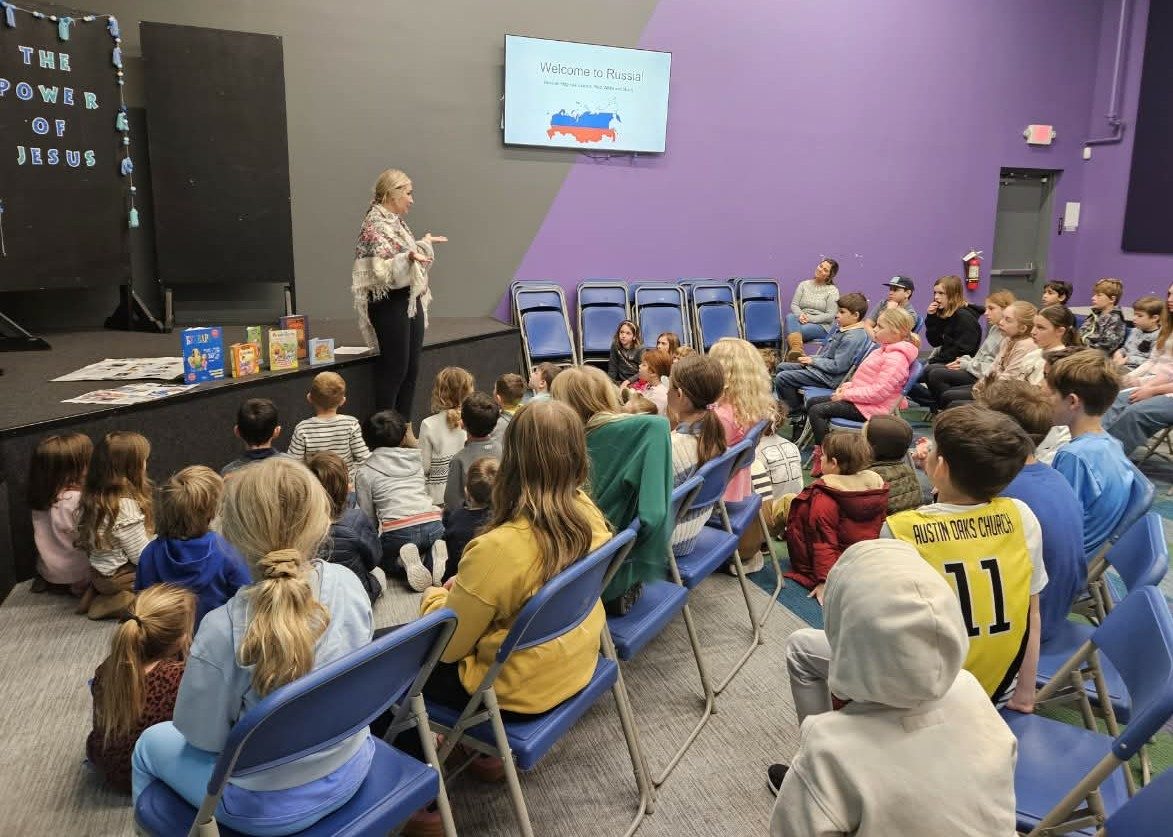 A guest presenter giving a Welcome to Russia talk to students seated in rows